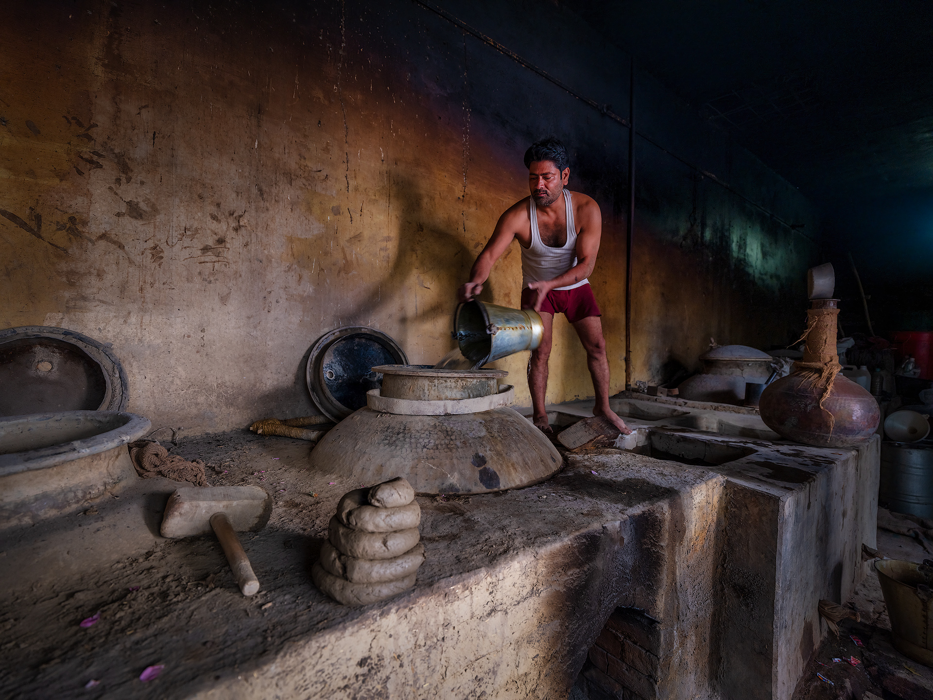 At Mohammed Faiz’s distillery, a worker adds water to the deg after placing in the fresh rose petals. The ratio of water to flowers is very precise and based on centuries of experience.
